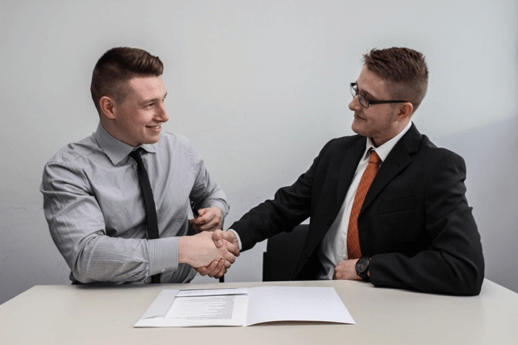 photo of two professional men shaking hands