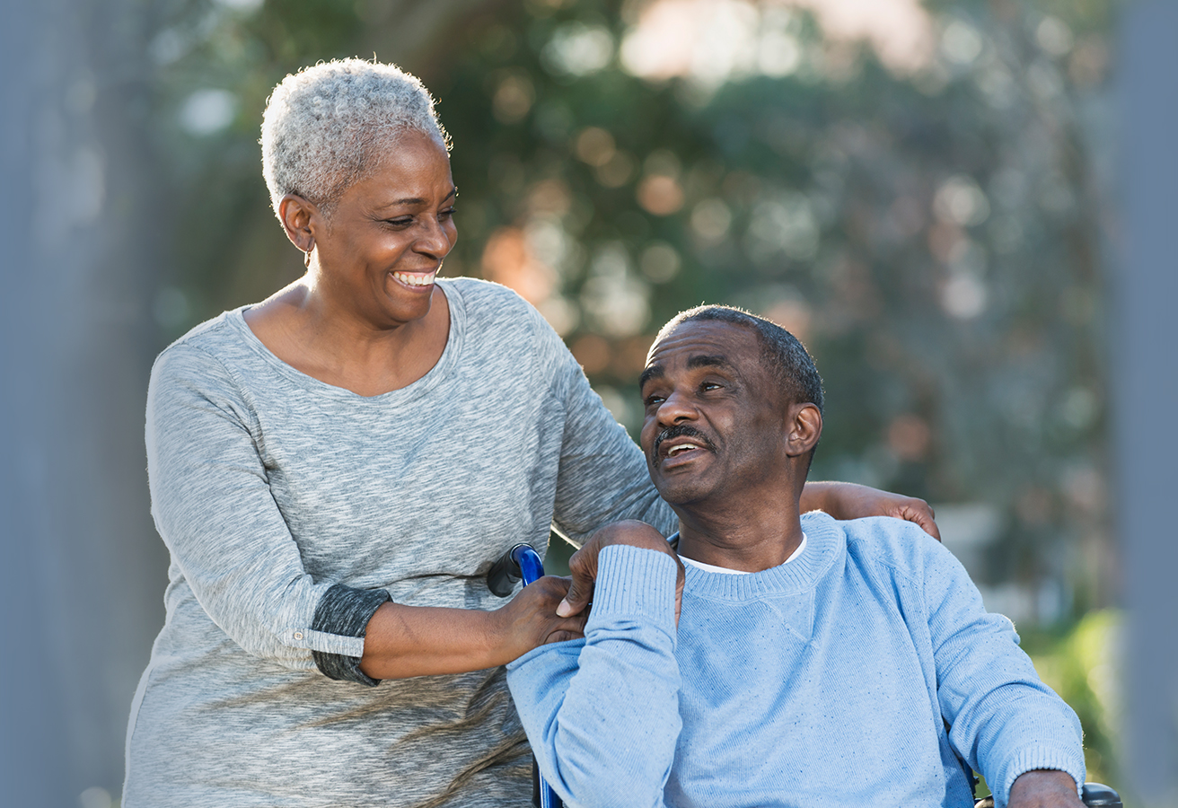 ACES$ Alabama caregiver hugging a teen boy with developmental disabilities