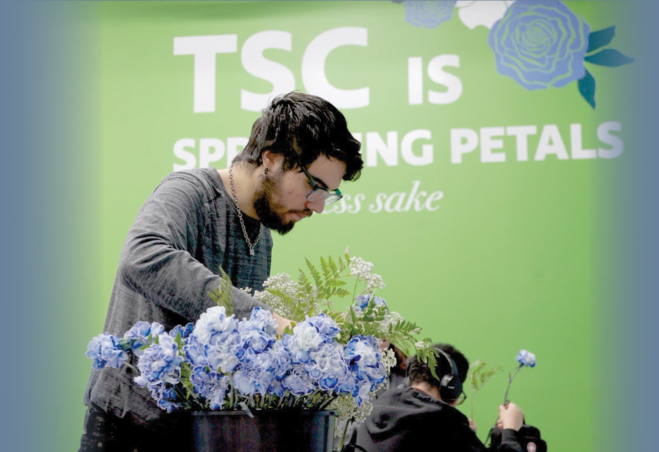 ACES$ Alabama caregiver hugging a teen boy with developmental disabilities