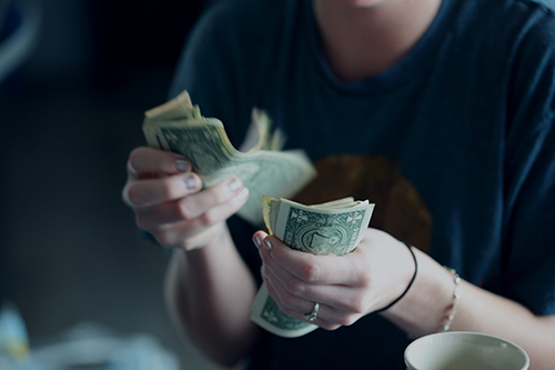Photo of person counting money